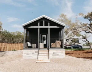 exterior view of luxury Cabins amongst trees and grass