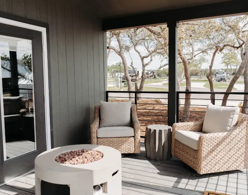 exterior view of luxury Cabin porch amongst trees and grass