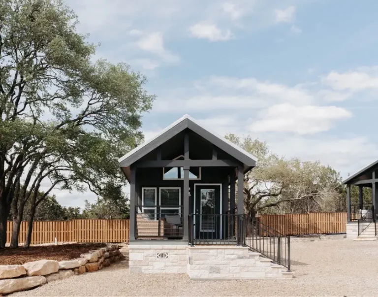 exterior view of luxury Cabins amongst trees and grass