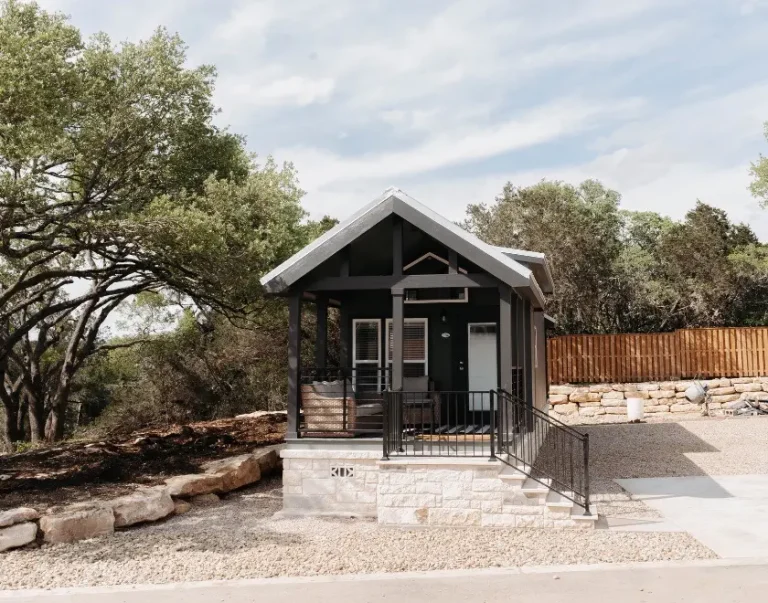 exterior view of luxury Cabins amongst trees and grass