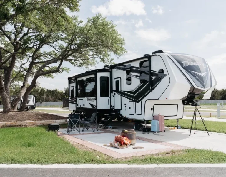 exterior view of RV site amongst trees and grass