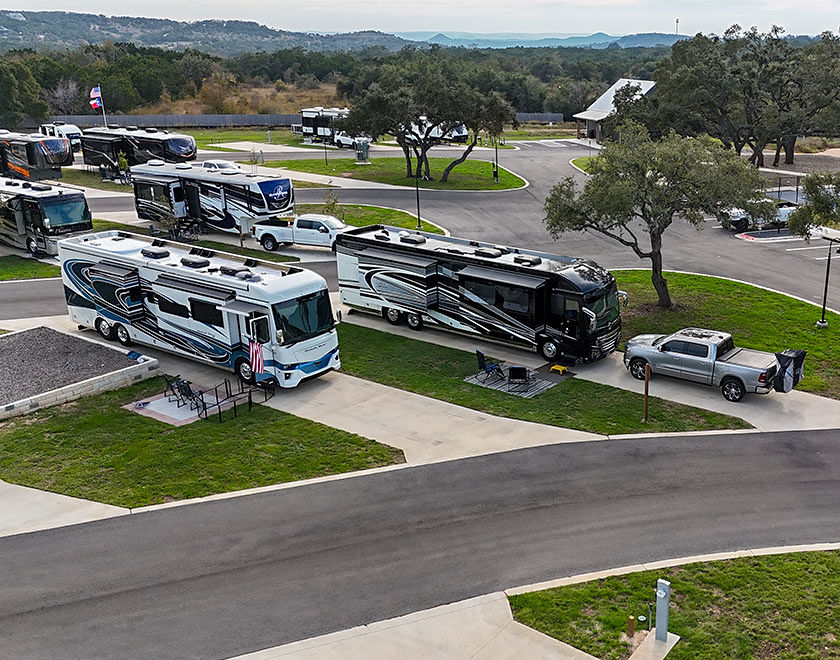 exterior view of RV site amongst trees and grass