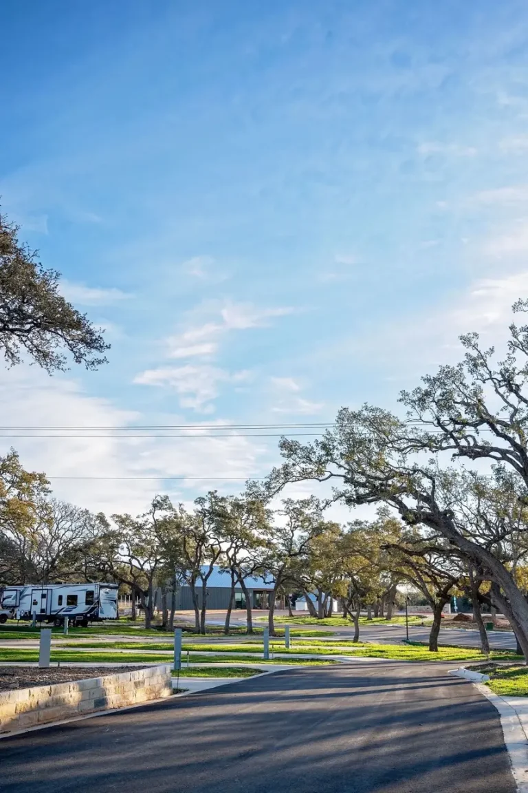 exterior view of RV site amongst trees and grass