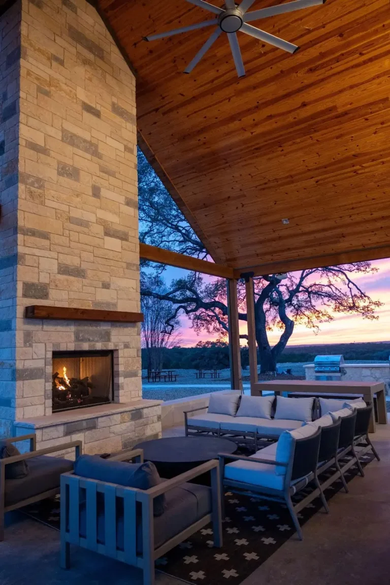 a patio with a fireplace and a couch