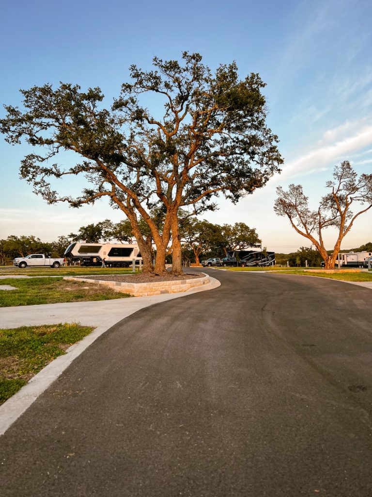 exterior view of RV site amongst trees and grass