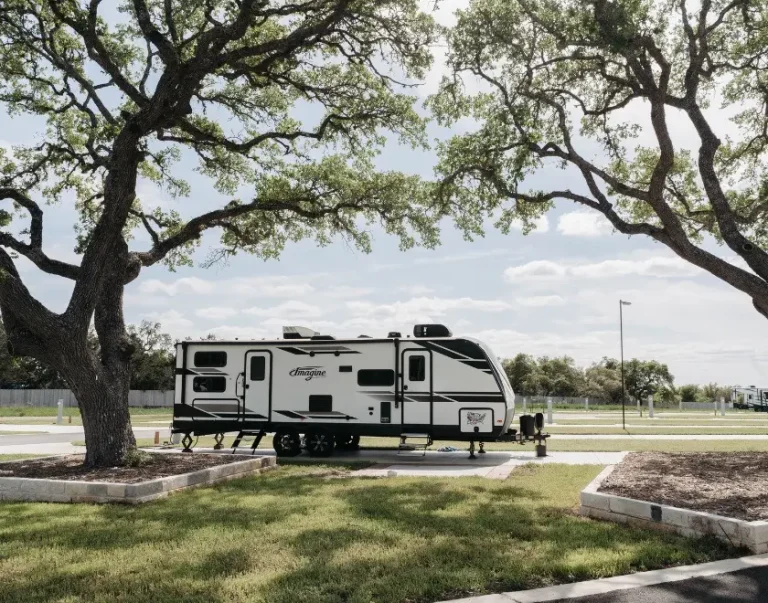 exterior view of RV site amongst trees and grass