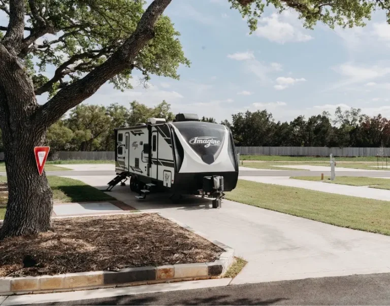 exterior view of RV site amongst trees and grass