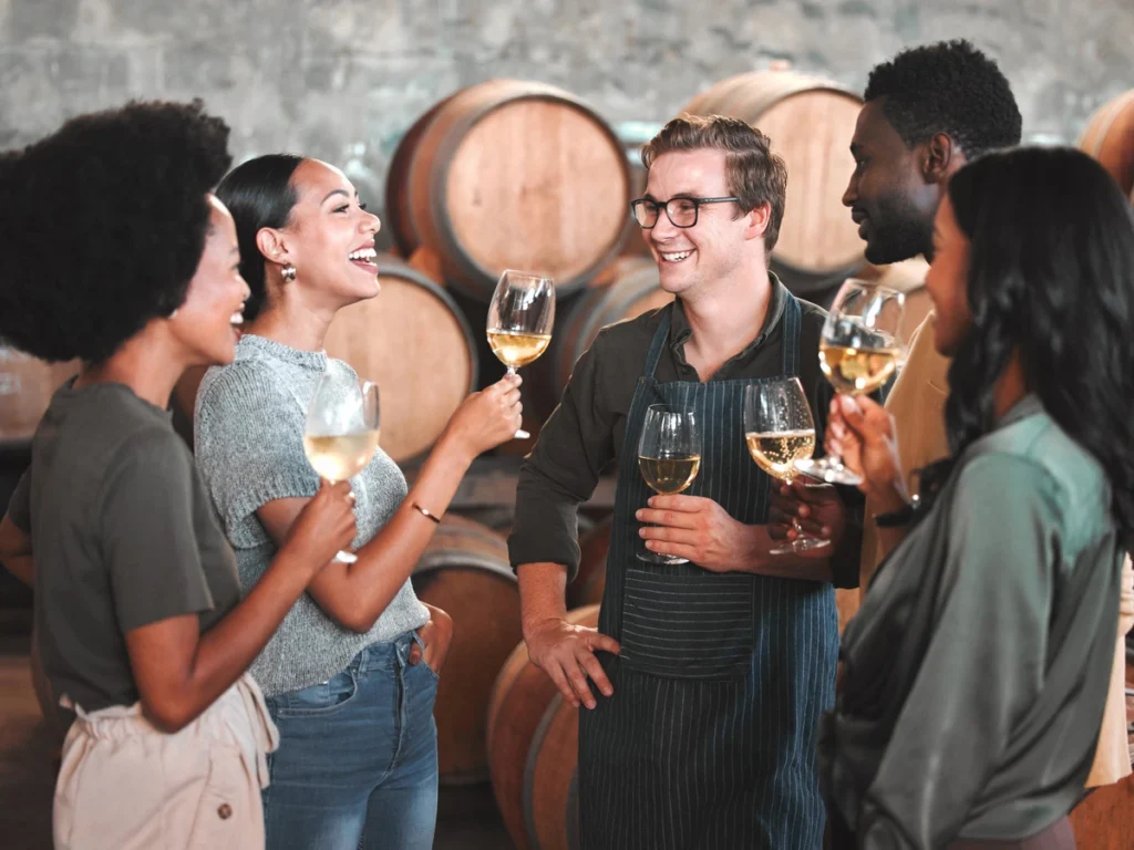 group of friends wine tasting at a winery