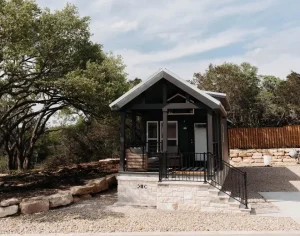 exterior view of luxury Cabins amongst trees and grass