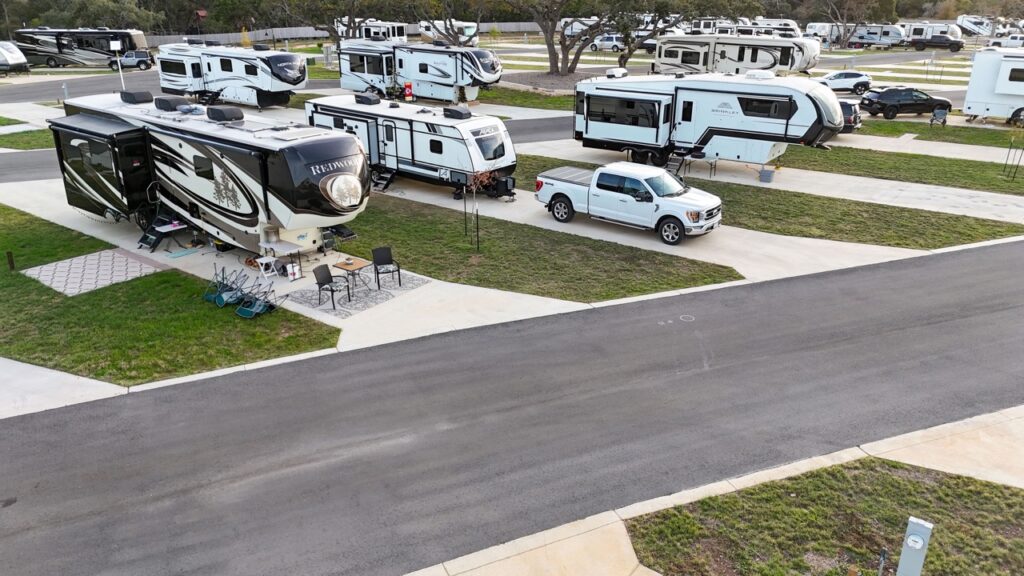 exterior view of luxury RV site amongst trees and grass
